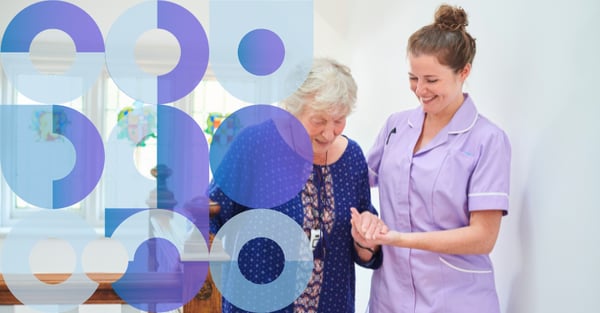 Female carer helping an older woman up stairs
