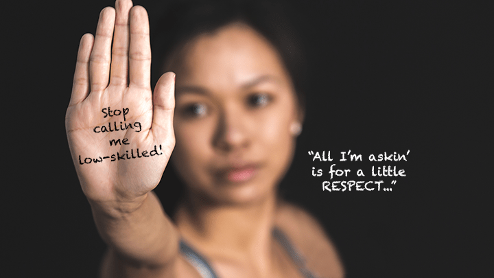 A carer with hand to the camera with the words written on it: