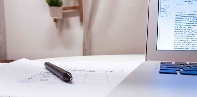 Close-up of a pen lying on top of a printed rota