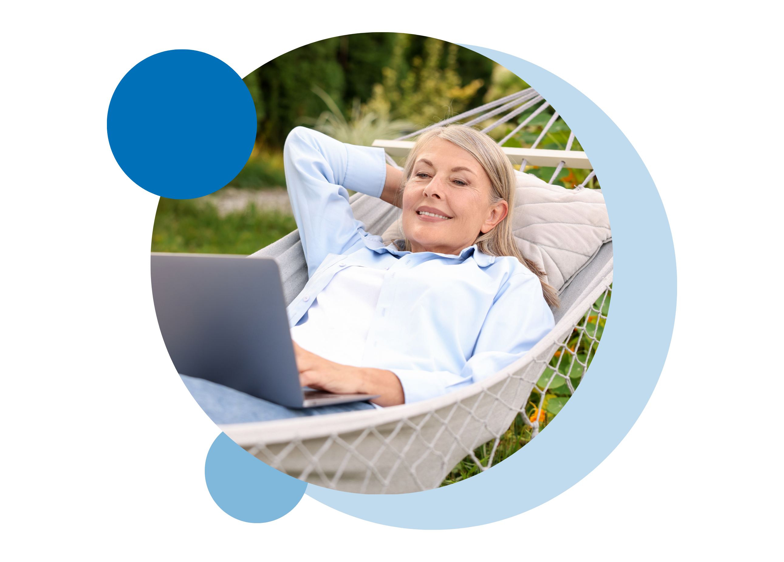 A woman relaxing lying in a hammock while using a laptop.