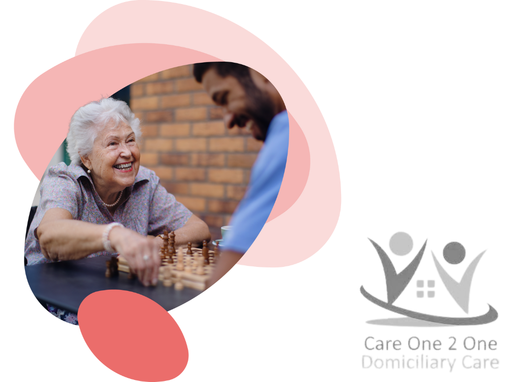 An elderly lady plays chess with a male carer plus Care One 2 One logo