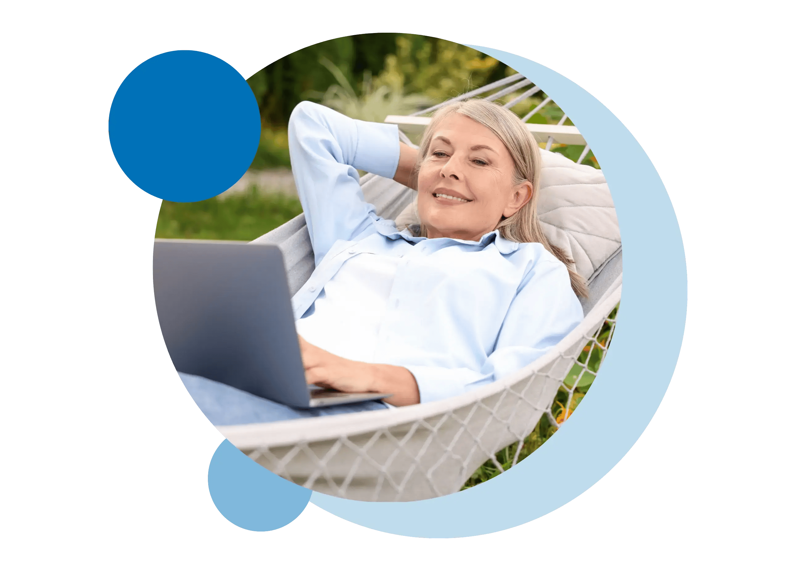 A woman relaxing lying in a hammock while using a laptop.